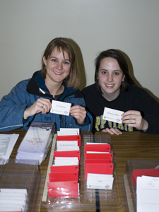 students holding business cards